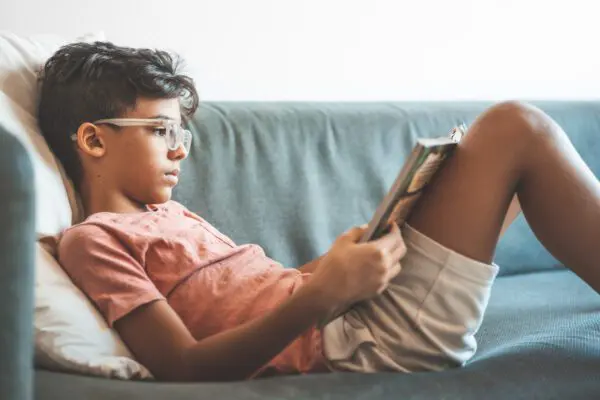 boy reading on a couch