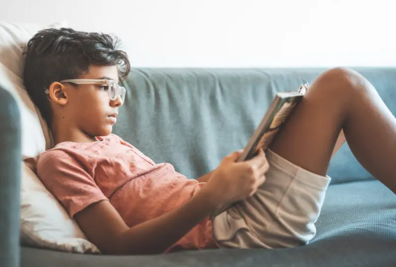boy reading on a couch