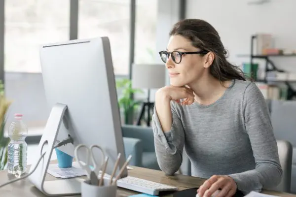 Woman with glasses looking at computer
