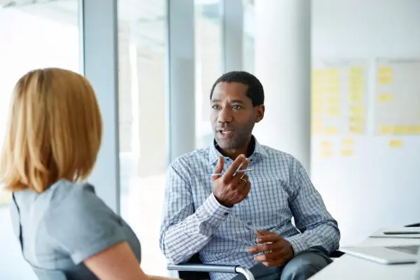 man talking with woman in conference room