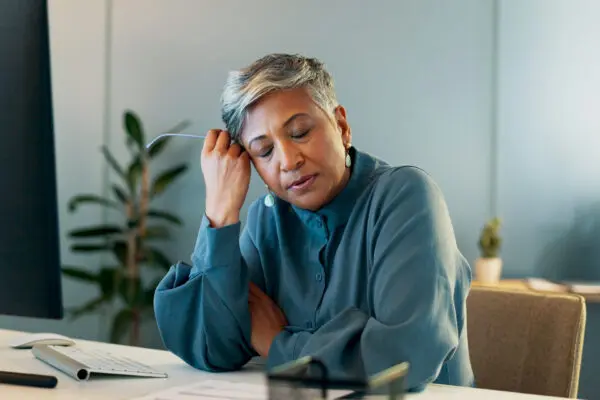 woman at her desk struggling with anxiety