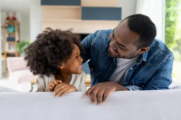 father and daughter at home smiling