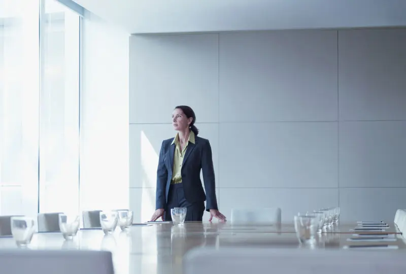 business woman standing alone in conference room