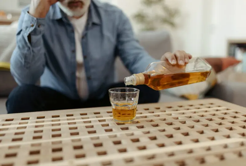 Man pouring a glass of whiskey