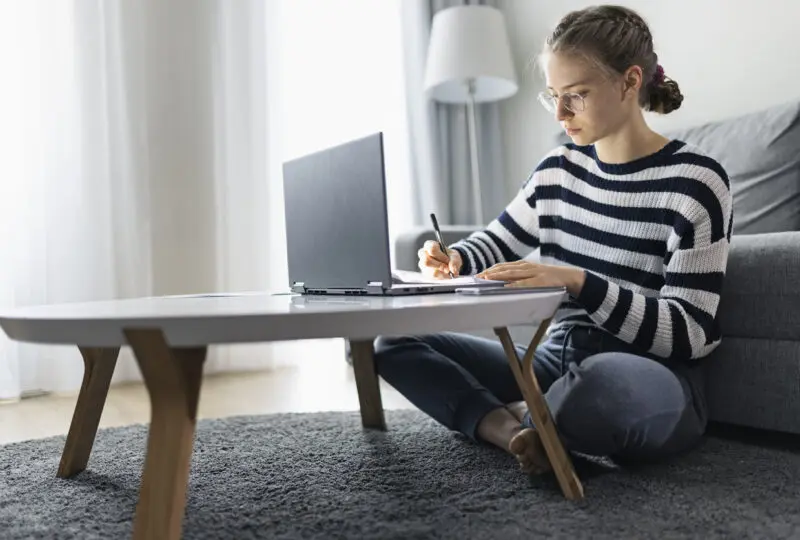 teen girl researching emancipation in Texas on laptop