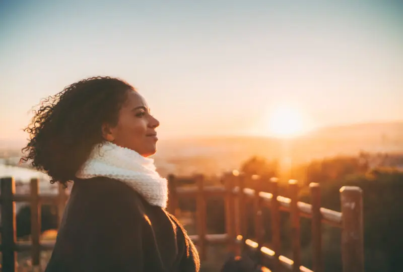 woman who is outside gazing into distance, divorcing with emotional well being