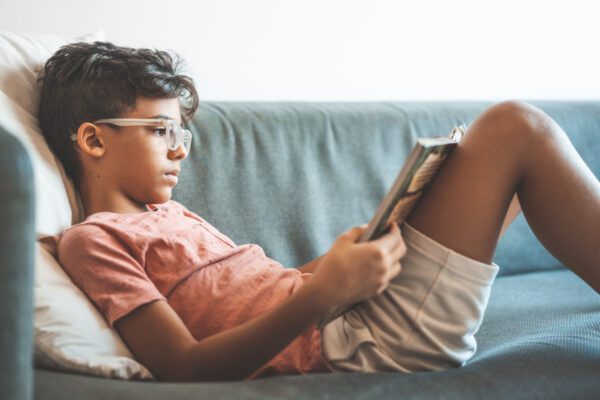 boy reading on a couch