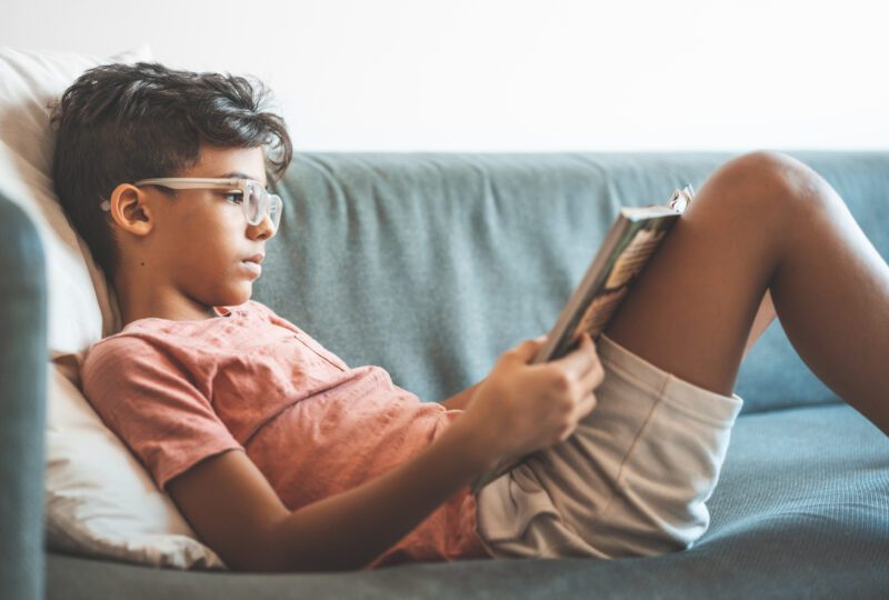 boy reading on a couch