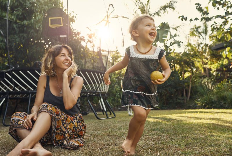 mother and child playing in backyard