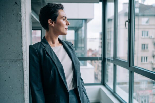 woman gazing out an office window
