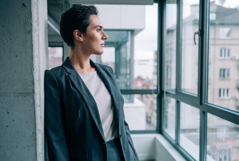 woman gazing out an office window