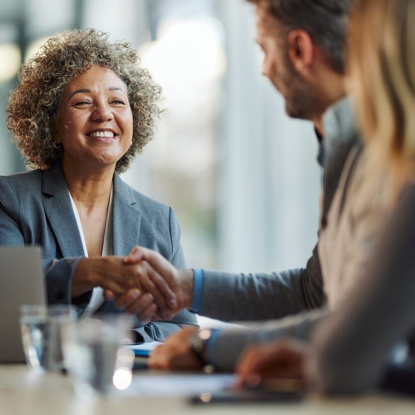 attorney and business valuator meeting with client in an office