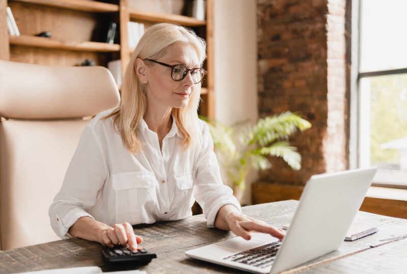 Middle-aged woman looking at laptop