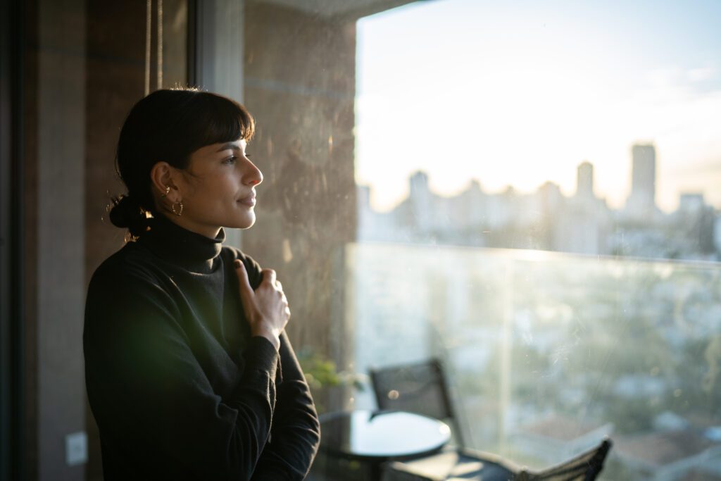 woman looking out window