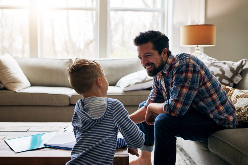 Father helping his little son with his homework