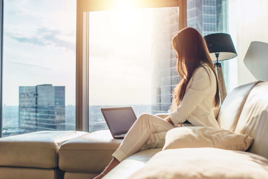 Woman in white powersuit looking at laptop