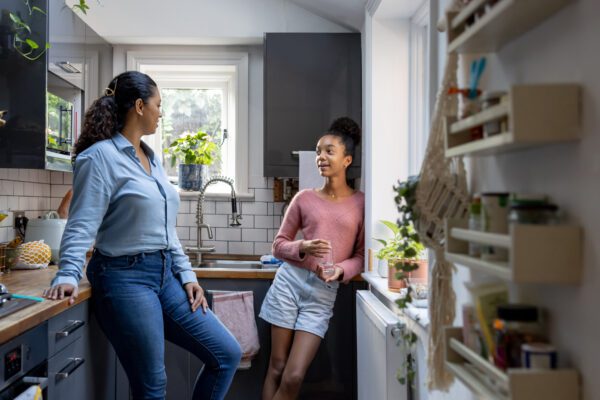 Mother and daughter talking in the kitchen