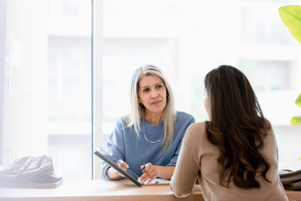 middle aged woman talking to lawyer