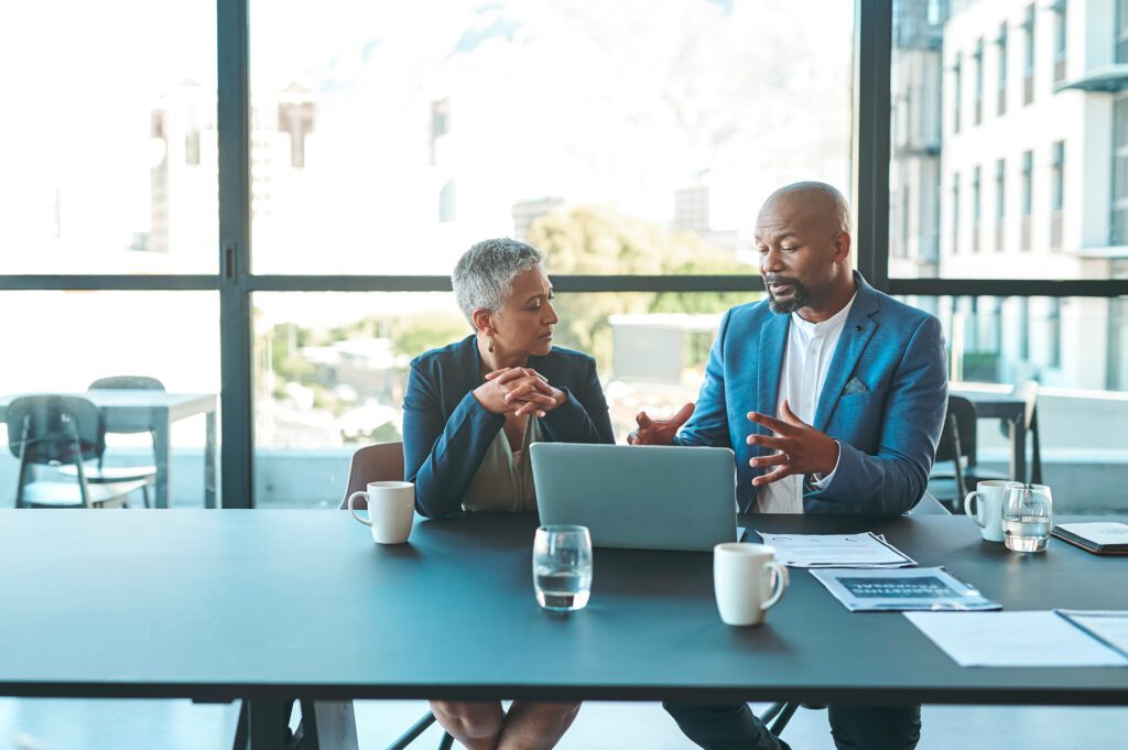 middle aged woman meeting with lawyer in boardroom