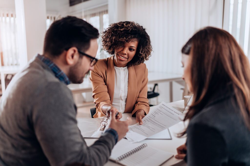 Couple looking at papers with an attorney