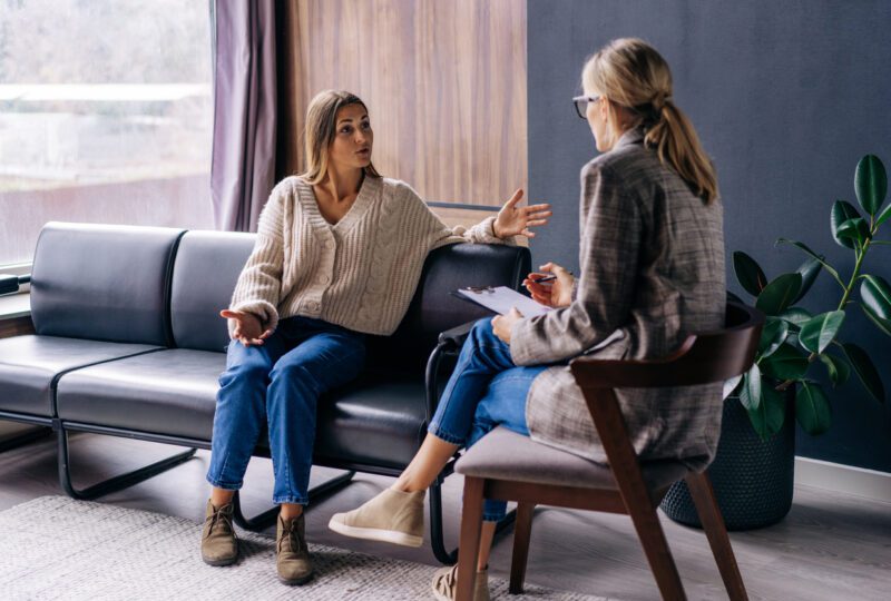 Woman speaking to divorce coach in an office