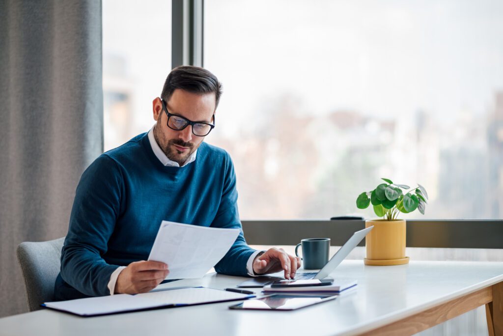 Man at his desk looking at papers