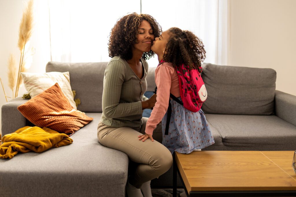 Mother preparing her daughter for school