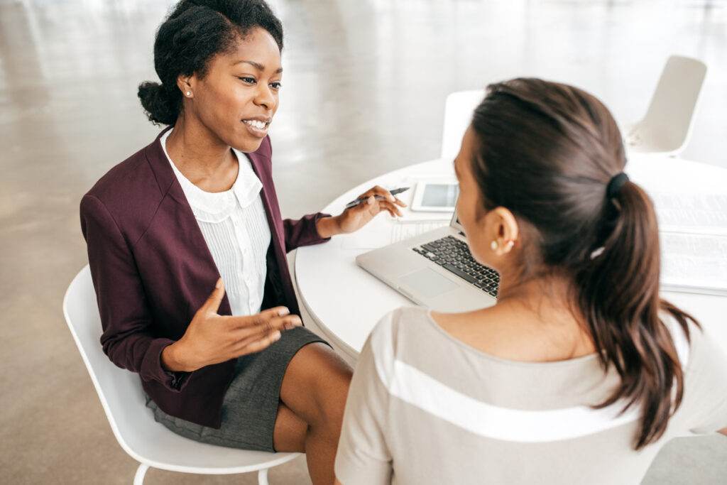 photo of lawyer talking to client at a conference table