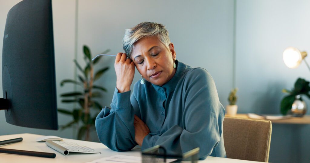 woman at her desk struggling with anxiety