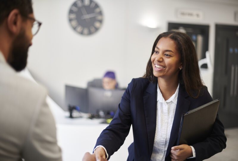 paralegal shaking hands with a client