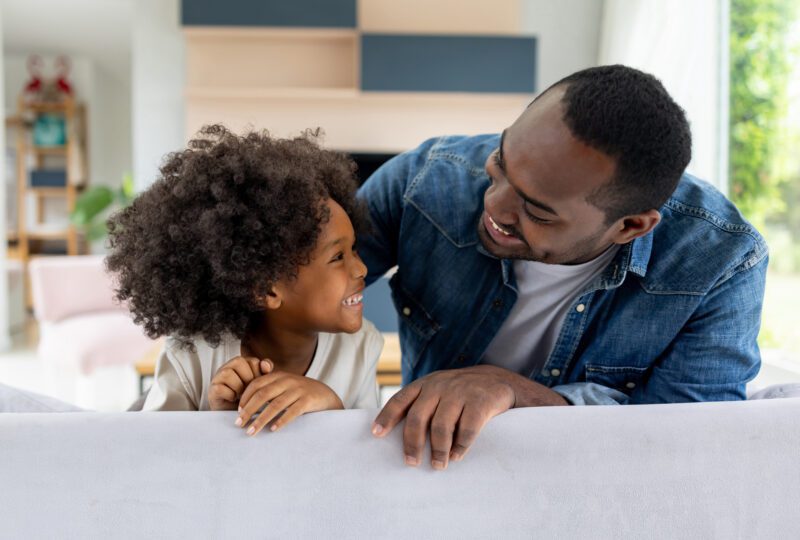 father and daughter at home smiling