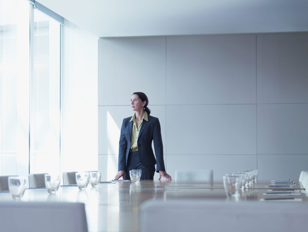 business woman standing alone in conference room