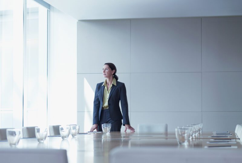 business woman standing alone in conference room