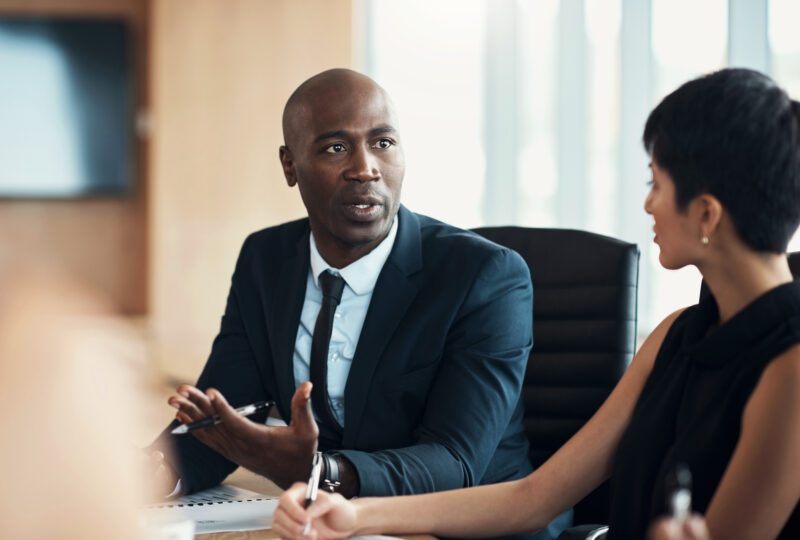 attorney in conference room talking to peers