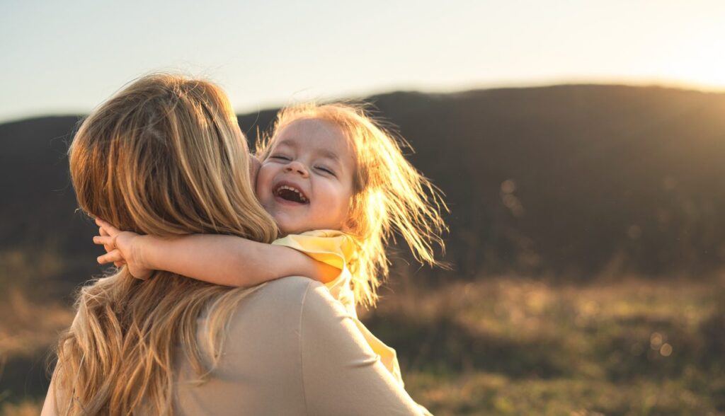 mother and daughter out for a walk, hugging