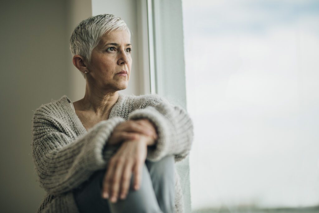 woman looking out window