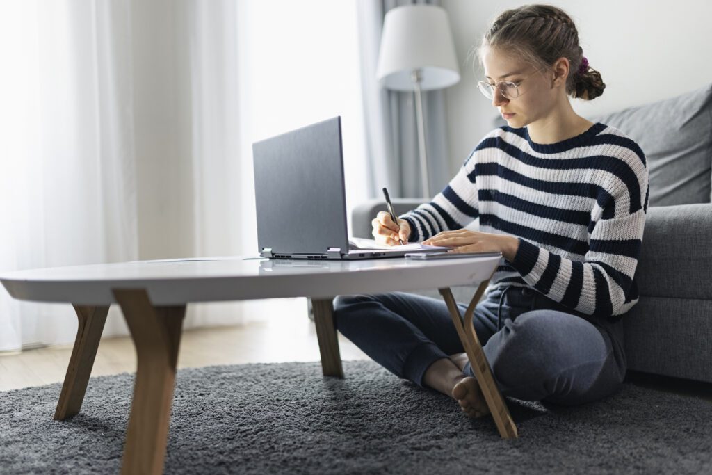 teen girl researching emancipation in Texas on laptop