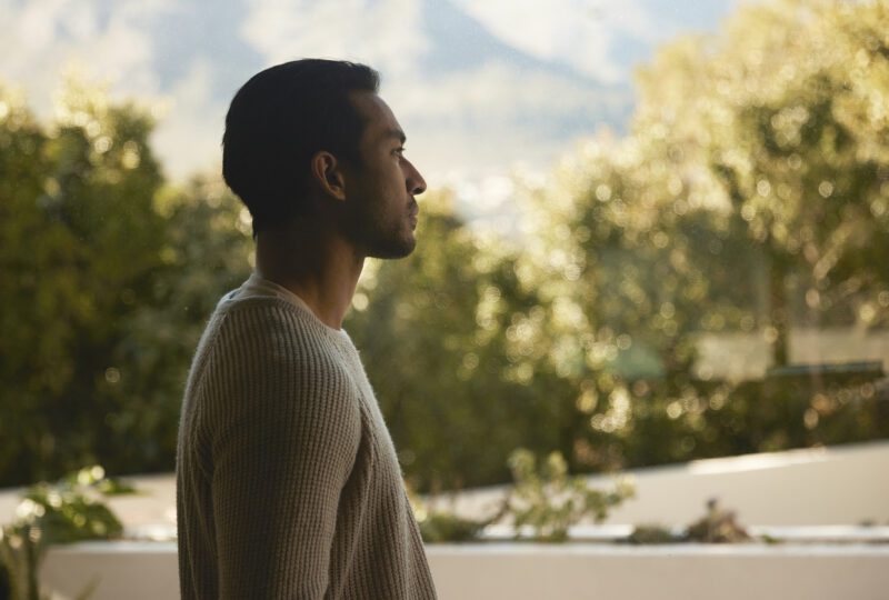 Man staring off into the distance while outside