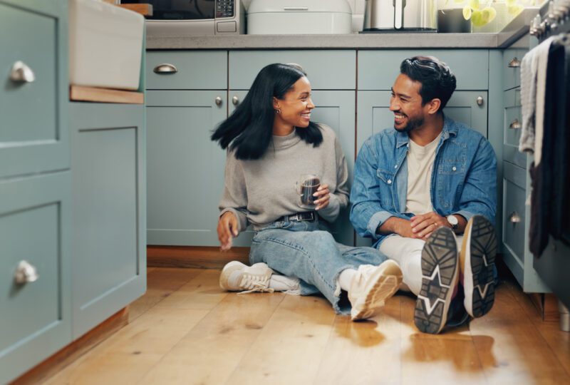 happy couple sitting in their kitchen having a conversation