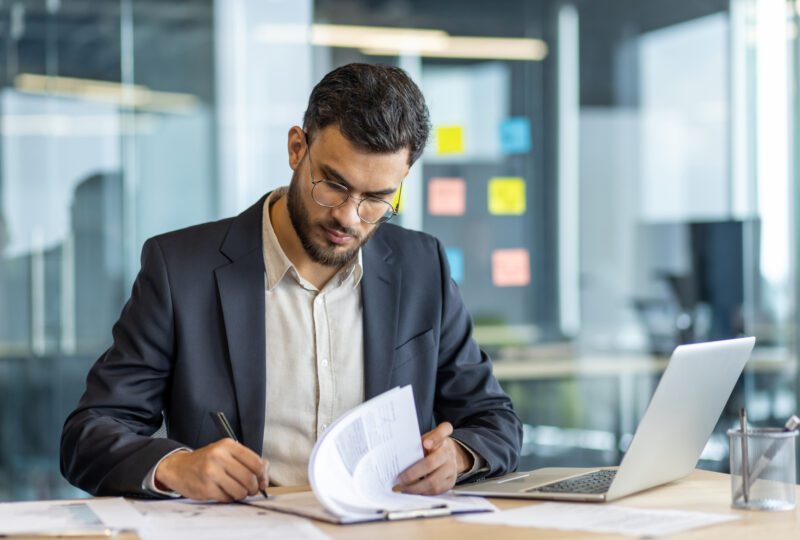 business man at his desk signing papers