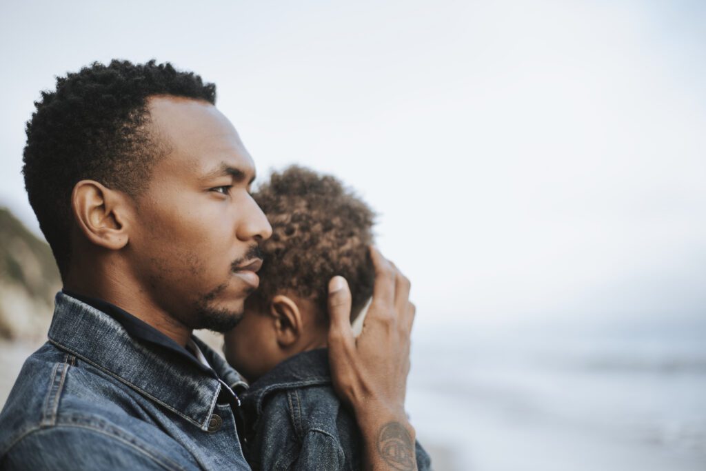 father holding his son in his arms