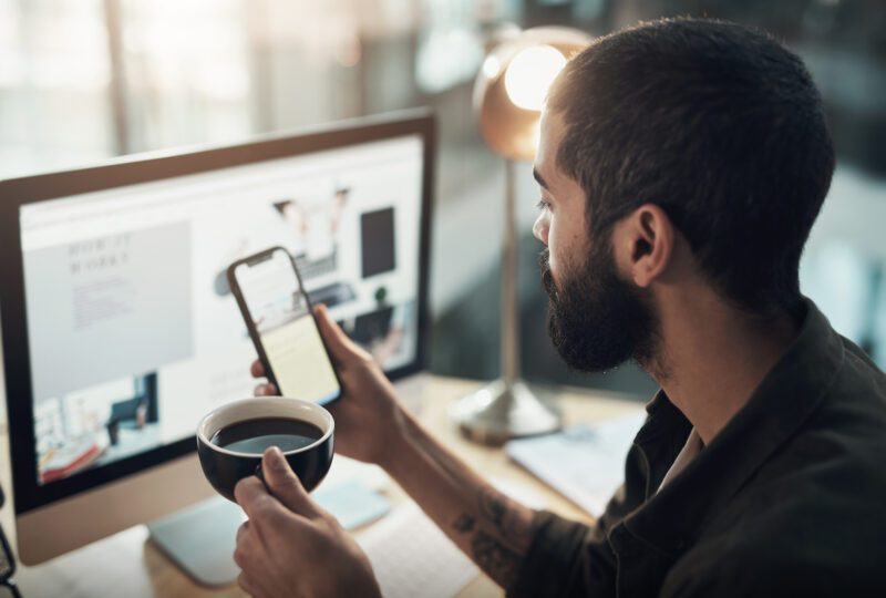 man at desk looking at social media account