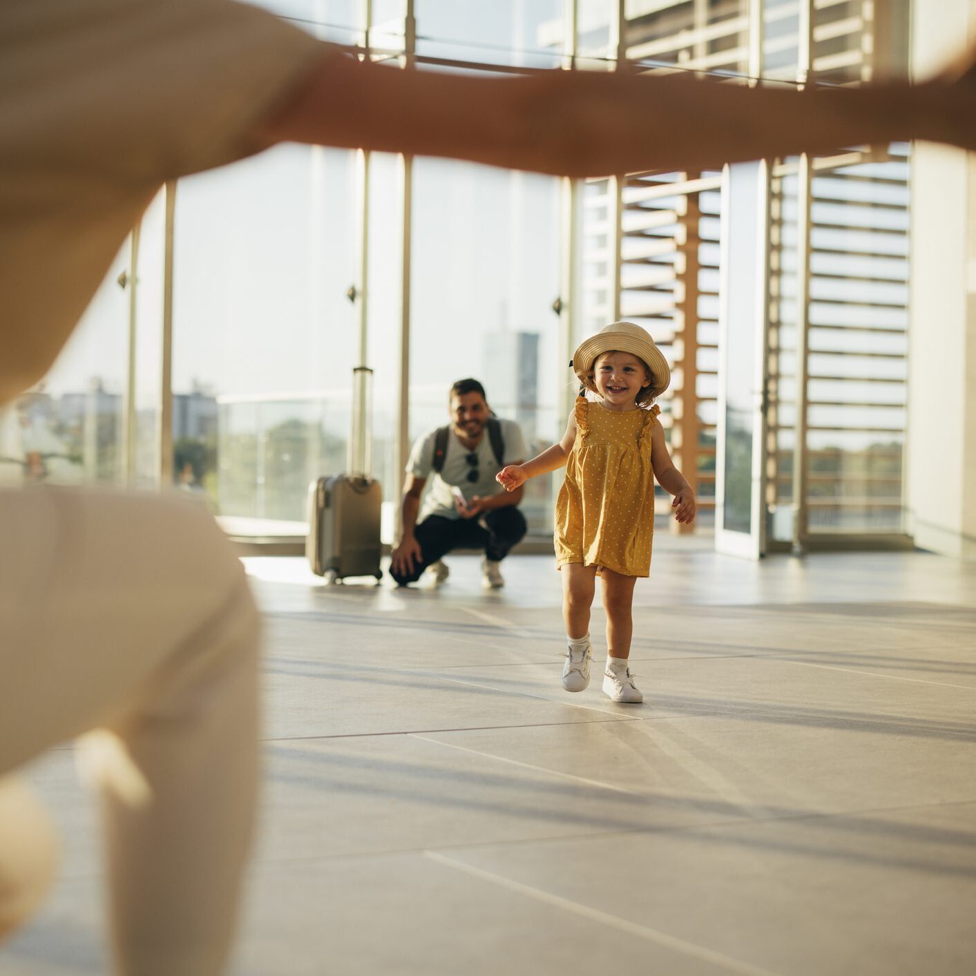 daughter running into mothers arms at airport