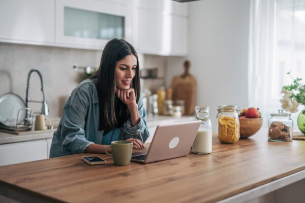 woman working on her laptop at kitchen island