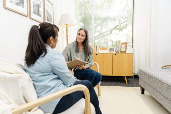 woman speaking with divorce coach in an office