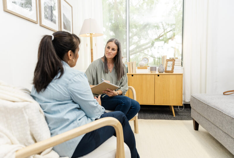 woman speaking with divorce coach in an office