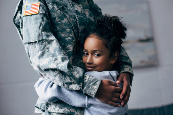 daughter hugging military parent