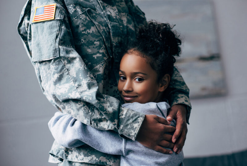 daughter hugging military parent