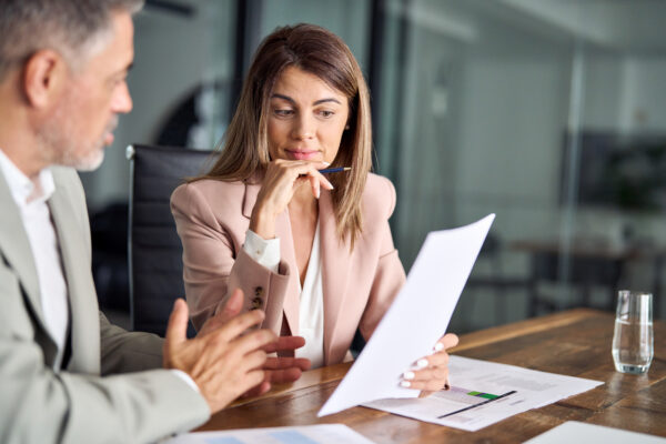 two lawyers discussing paperwork